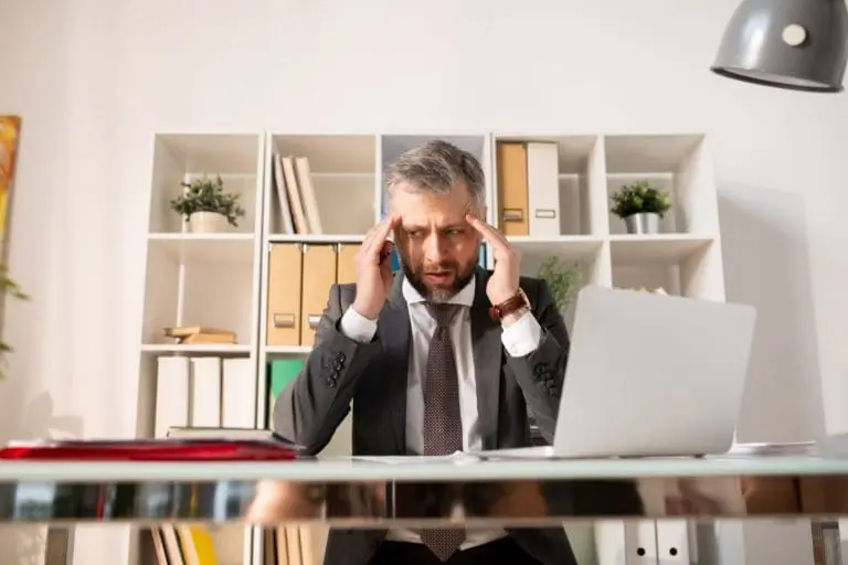 Depressed businessman confused with paperwork