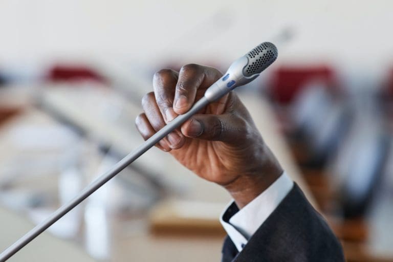 Businessman speaking in microphone